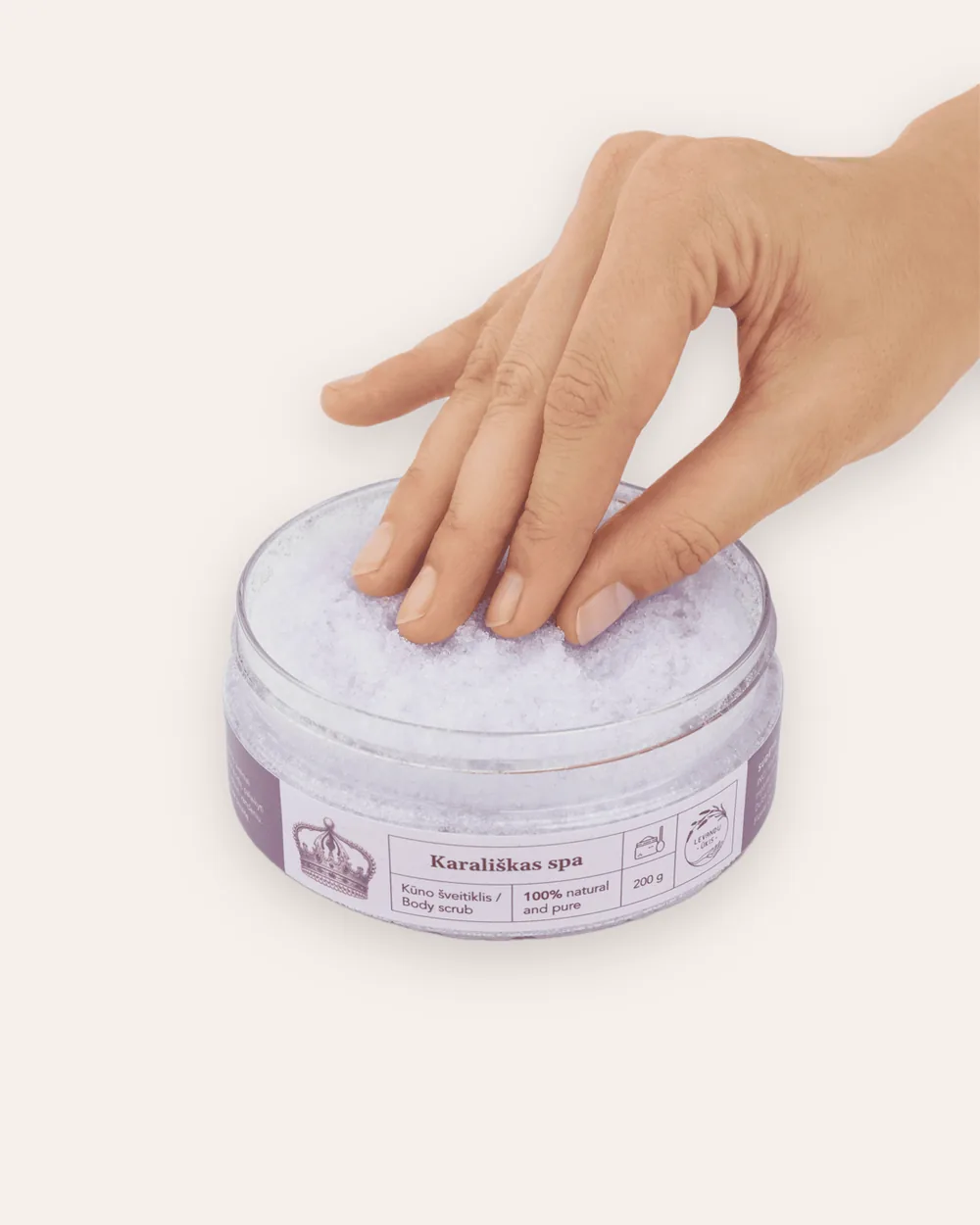 Open “Royal SPA” lavender body scrub with white salt grains, a hand touching it