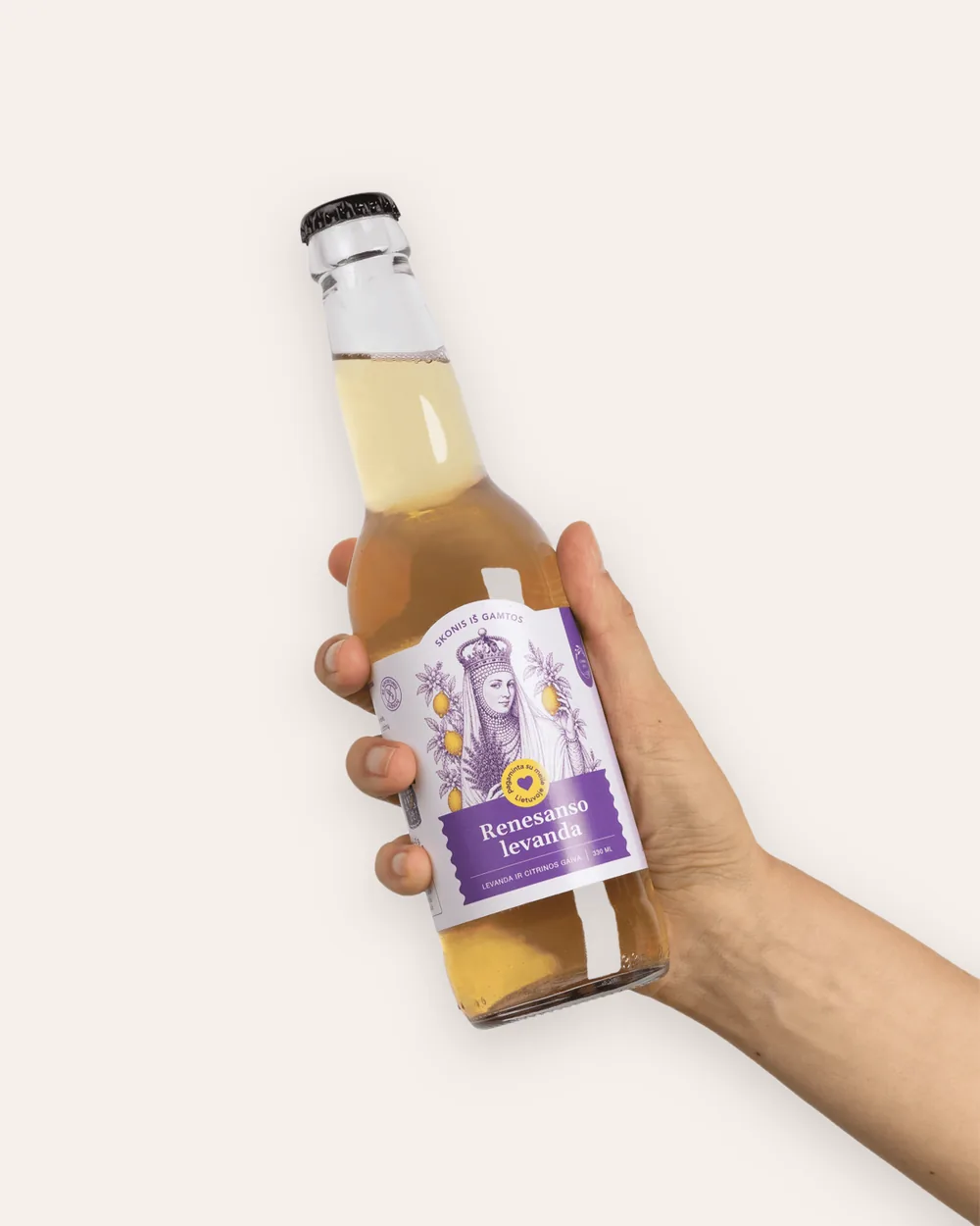 Hand holding an open bottle of “Renaissance Lavender” sparkling lavender lemonade