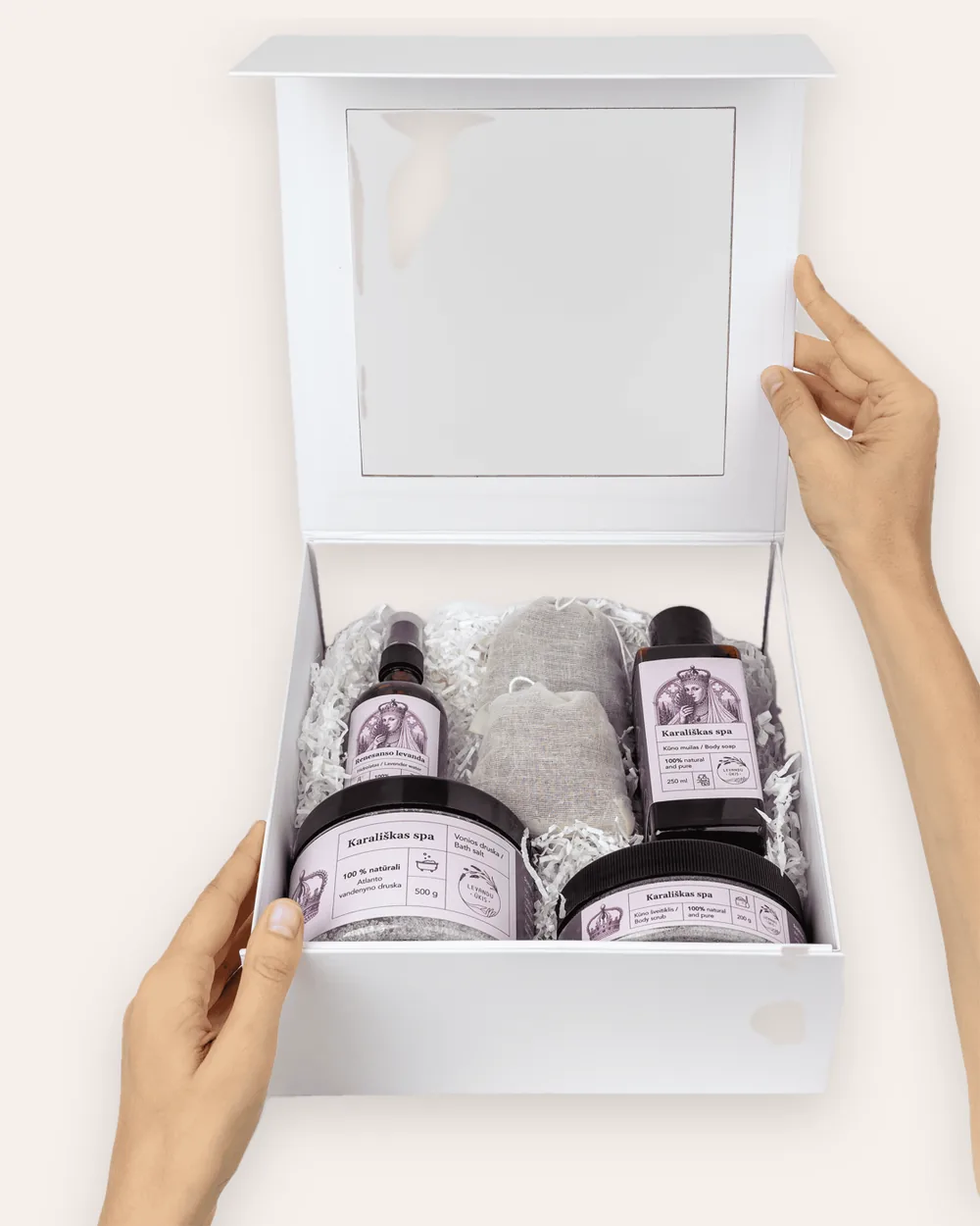 Open white gift box “Royal SPA” with lavender products, held in hands