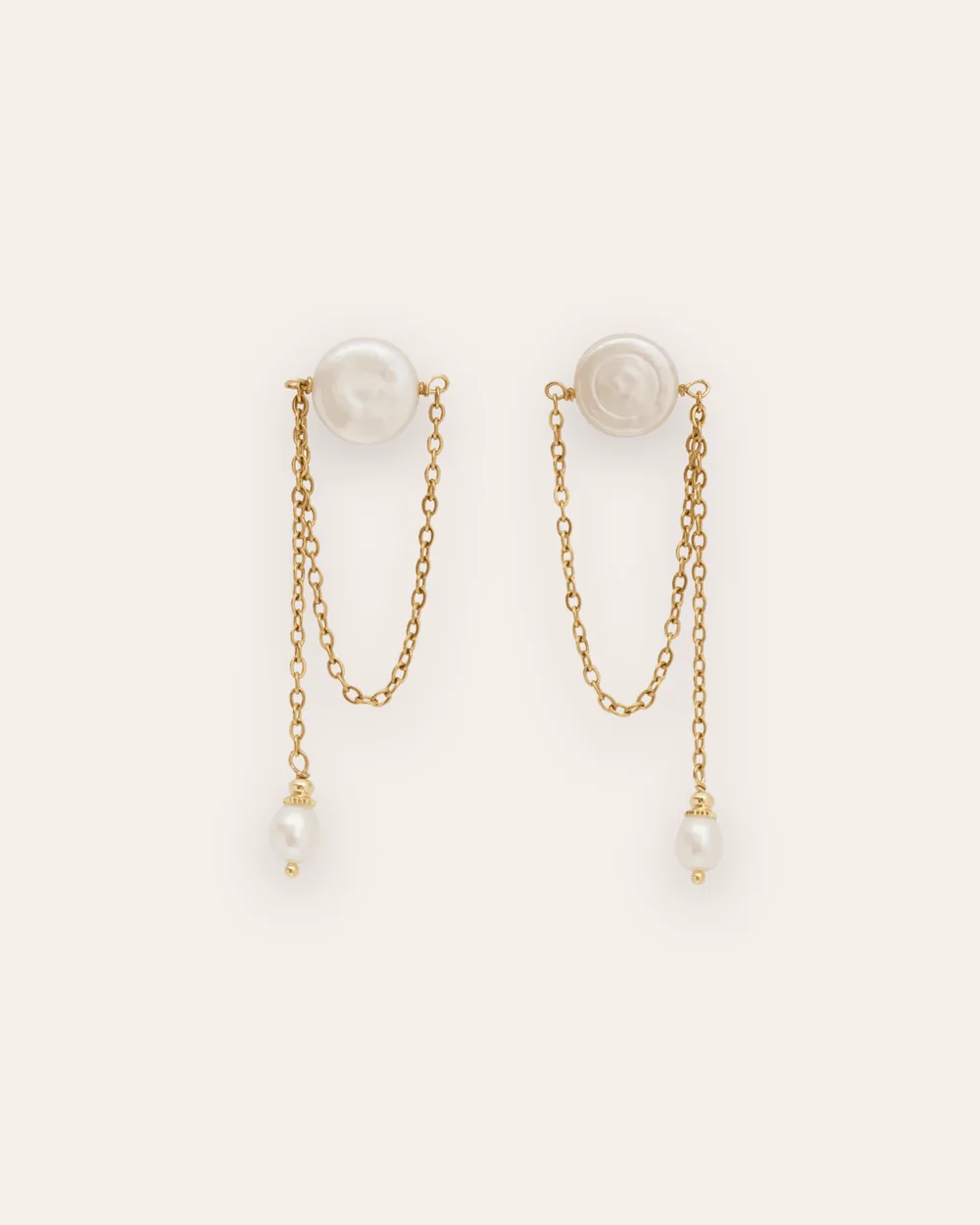 Gold earrings “The Queen's Morning” with a round pearl and dangling chains on a light background